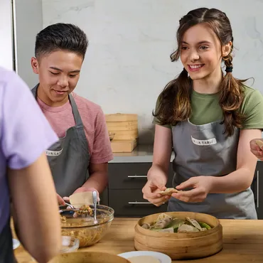teens in Sur La Table kitchen making dumplings